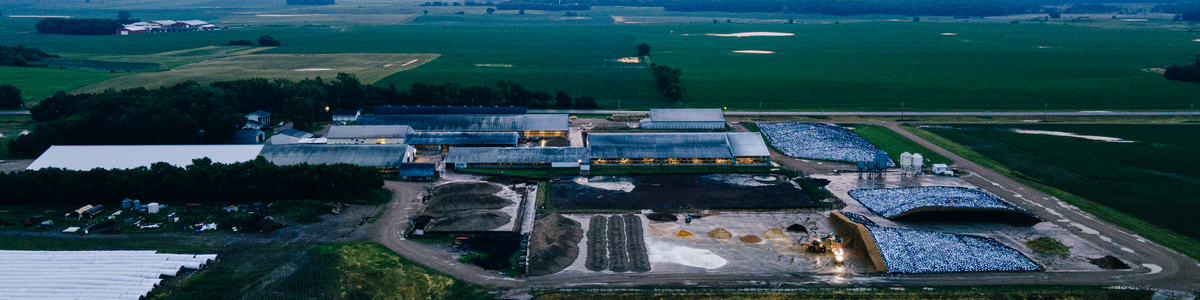 Appraiser evaluating a modern dairy farm with milking facilities and livestock buildings.